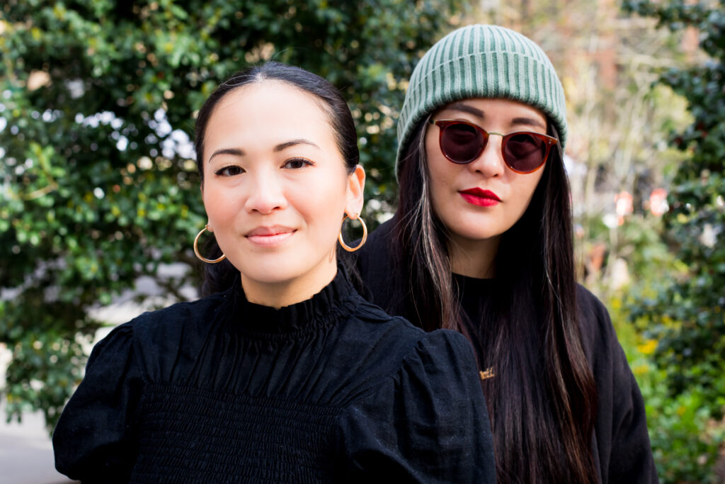 A portrait of two women wearing black.