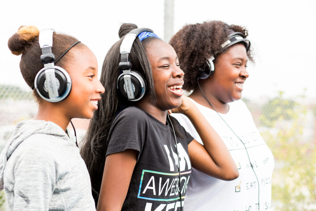 3 girls wearing headphones