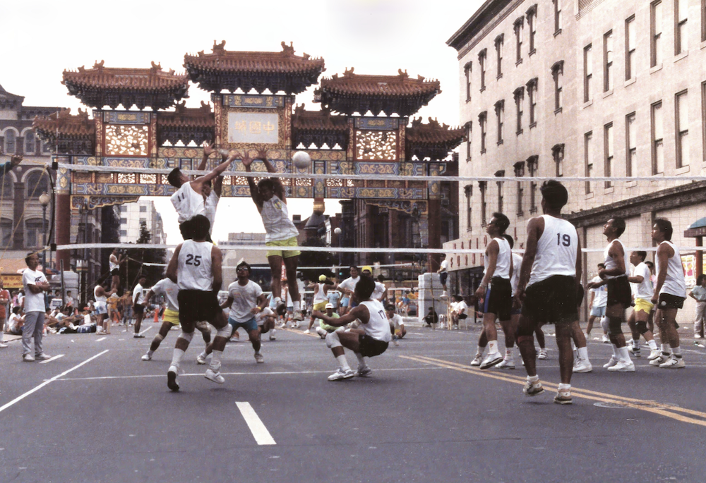 A group of men playing volleyball in the streets of Washington, DC, 1989.