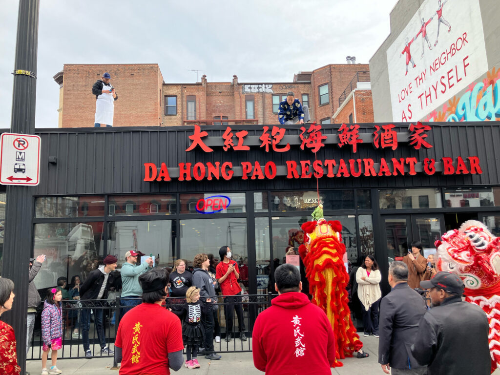 Lion Dancers perform for an audience in front of Da Hong Pao Chinese restaurant in Washington, D.C.